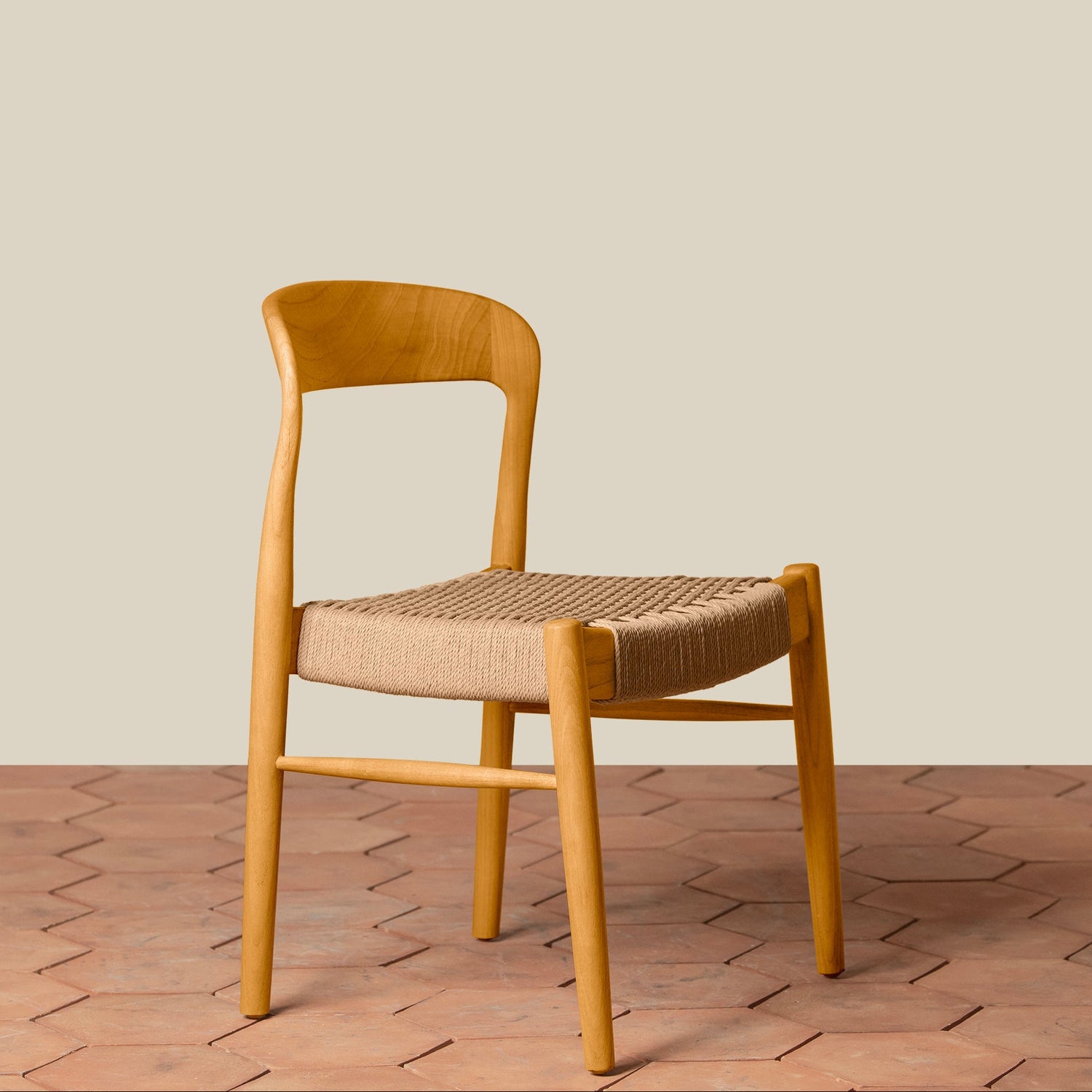 Wooden chair with woven seat on a wooden floor and beige wall background- Number 14