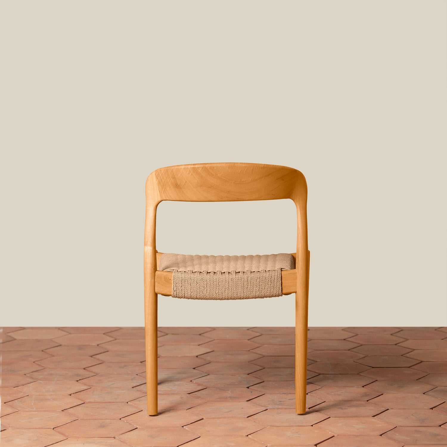 Wooden chair with woven seat on a wooden floor and beige wall background- Number 17