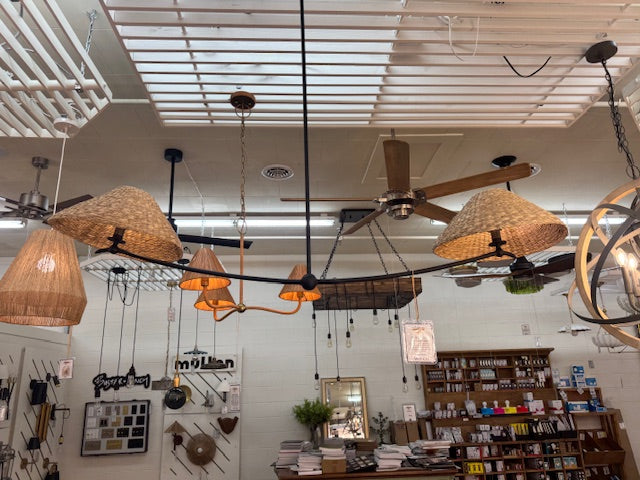 Ceiling fans and lights on display in a store with various products in the background.- Number 2