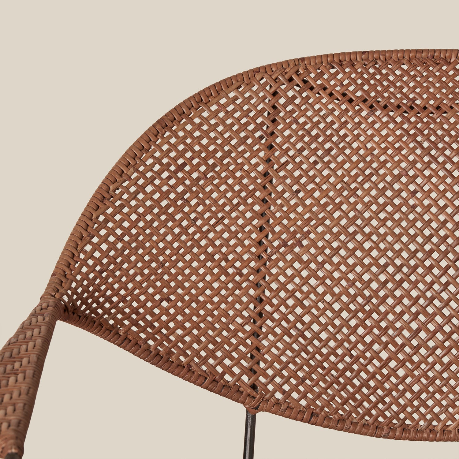 close up of brown rattan chair back against white background- Number 6