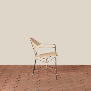 white and black rattan and iron chair with pointed legs on tiled floor against white background - Number 10