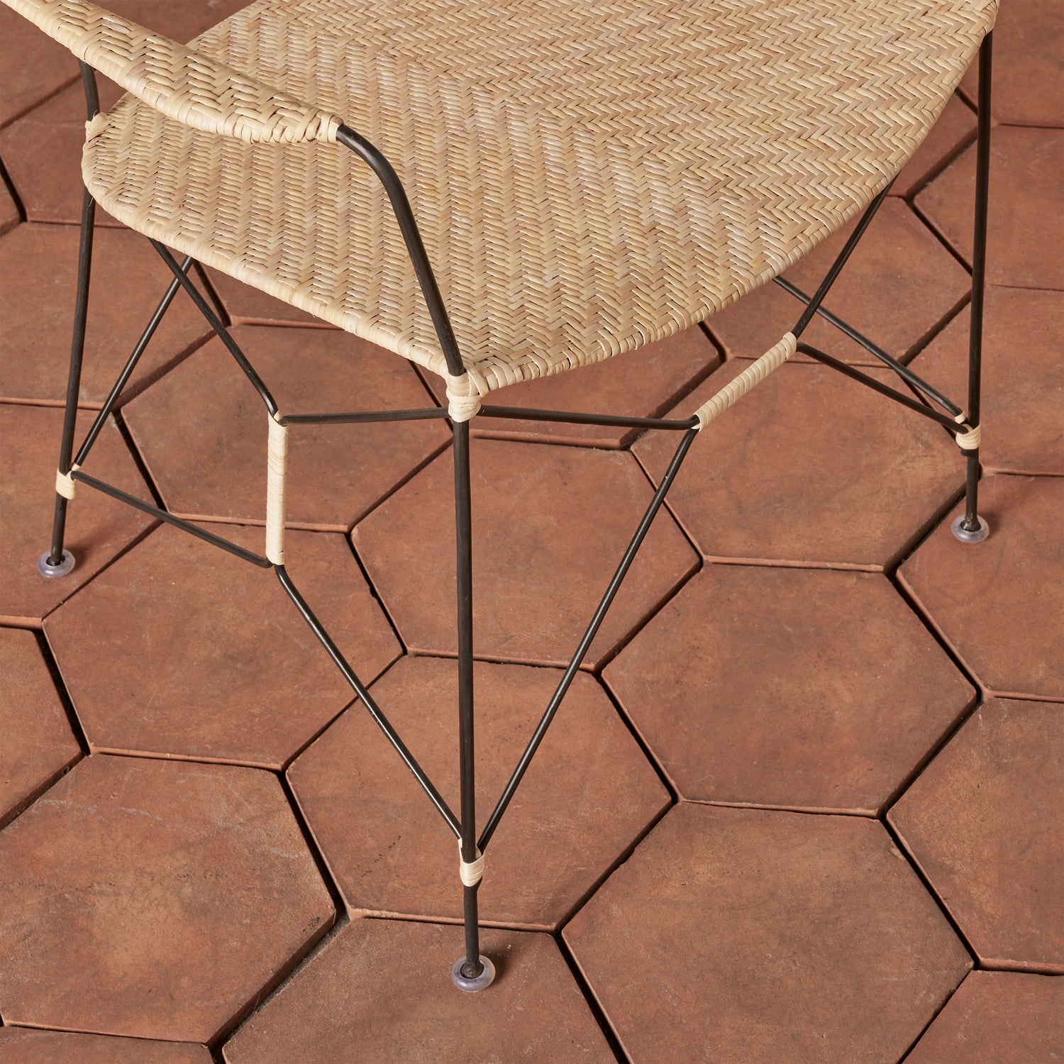 closeup of white and black chair seat and legs on tiled floor - Number 12