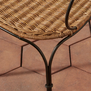 Close-up of a woven wicker or rattan tabletop with a dark metal frame, shown on terracotta tiled flooring. - Number 8