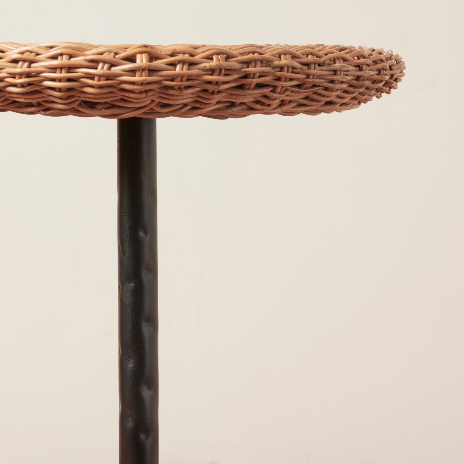 Wicker stool with a black metal base on a beige background- Number 6