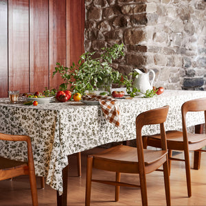 wood chairs at table setting, with greens and tomatoes on top of table - Number 2