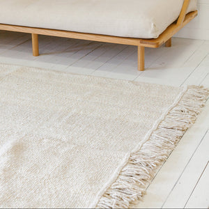 Beige sofa with wooden frame on a light wooden floor with a beige rug. - Number 2