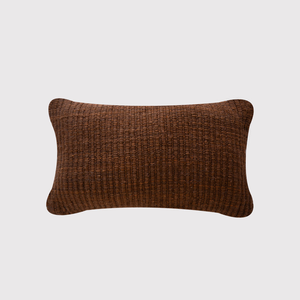Brown textured rectangular pillow on a light gray background- Number 1