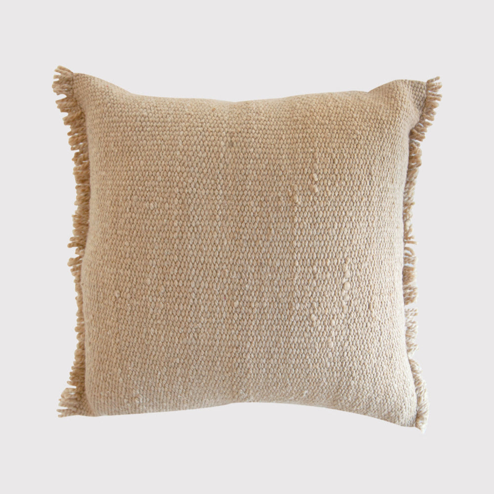 Beige textured pillow with fringes on a light gray background- Number 1