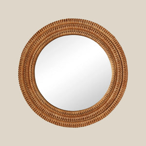 Round mirror with a woven wicker brown frame on a beige wall - Number 1