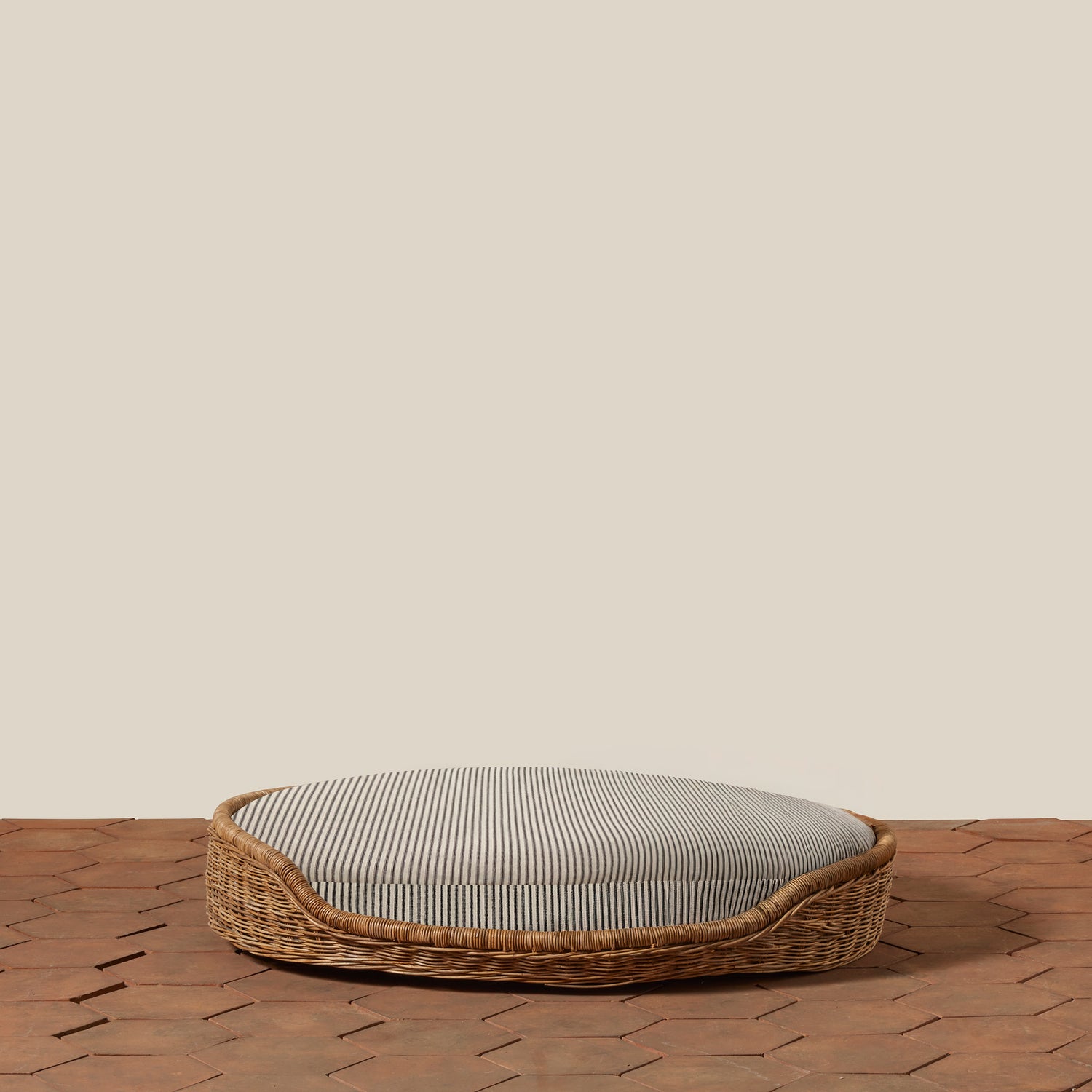black and white striped dog bed with woven exterior on tile floor- Number 18