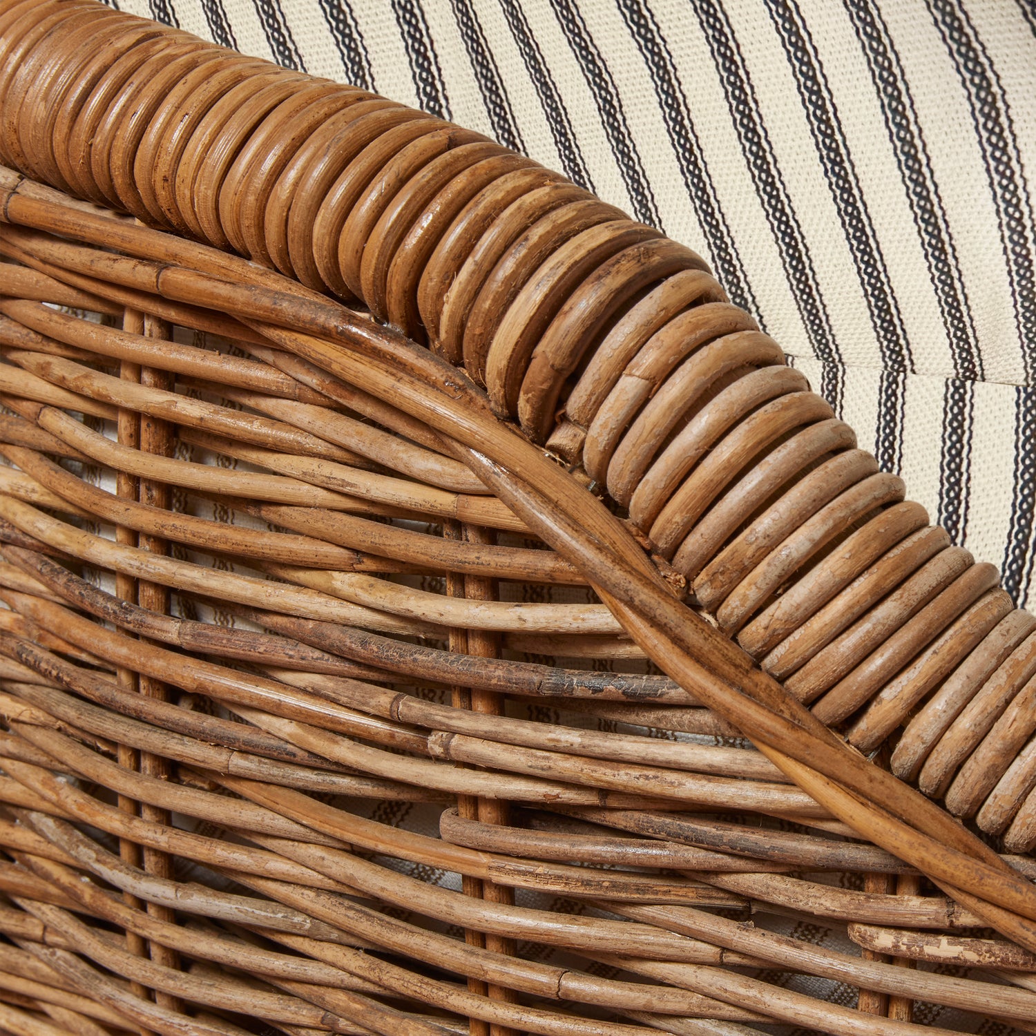 Close-up of wicker chair with striped fabric background- Number 16