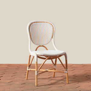 Wicker chair with white cushion on a wooden floor and beige wall background - Number 1