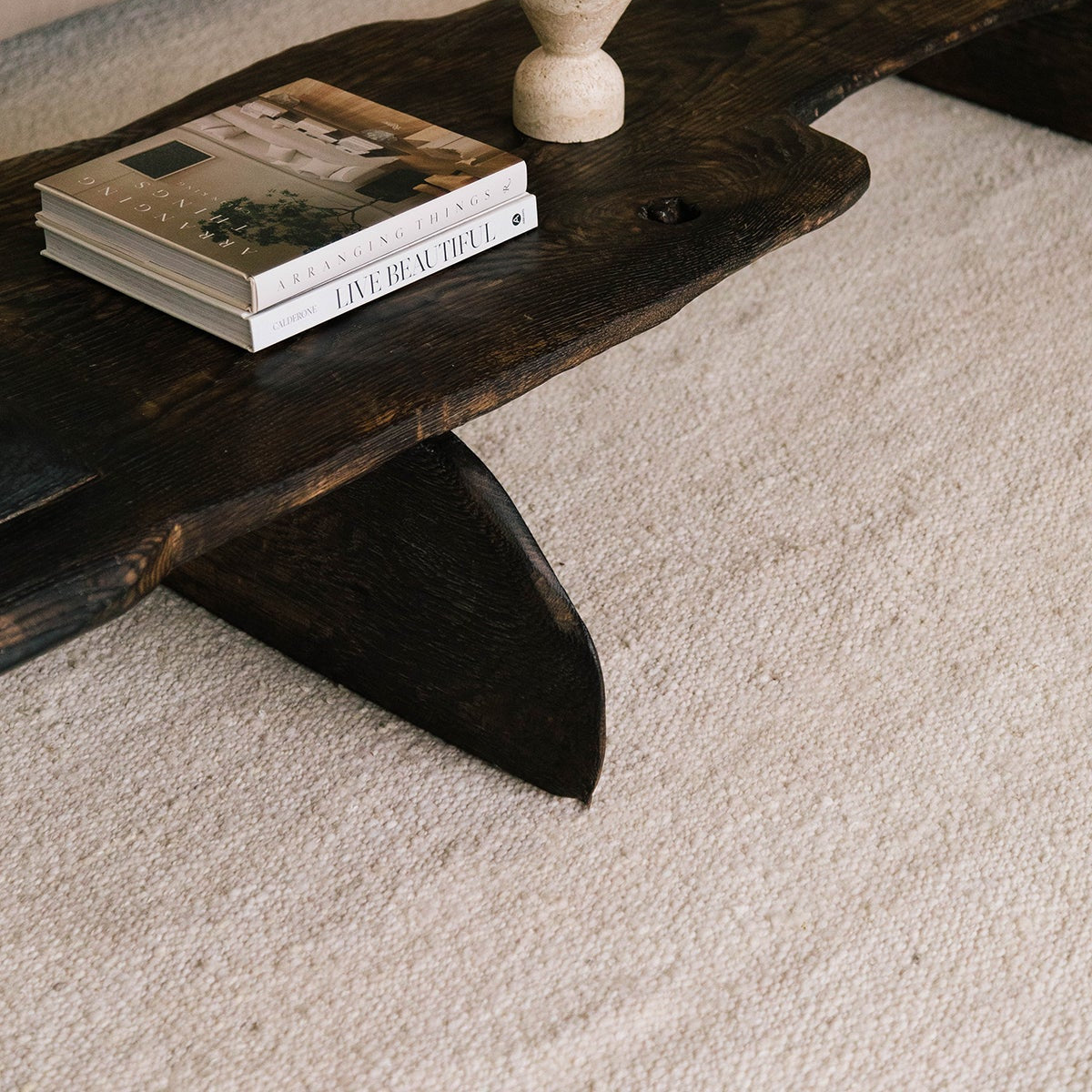 Wooden coffee table with books on a beige carpet- Number 2
