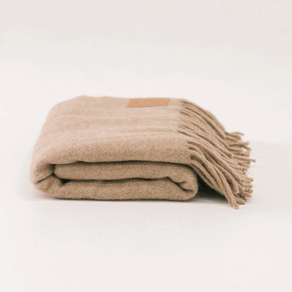 Folded beige blanket on a white background- Number 1