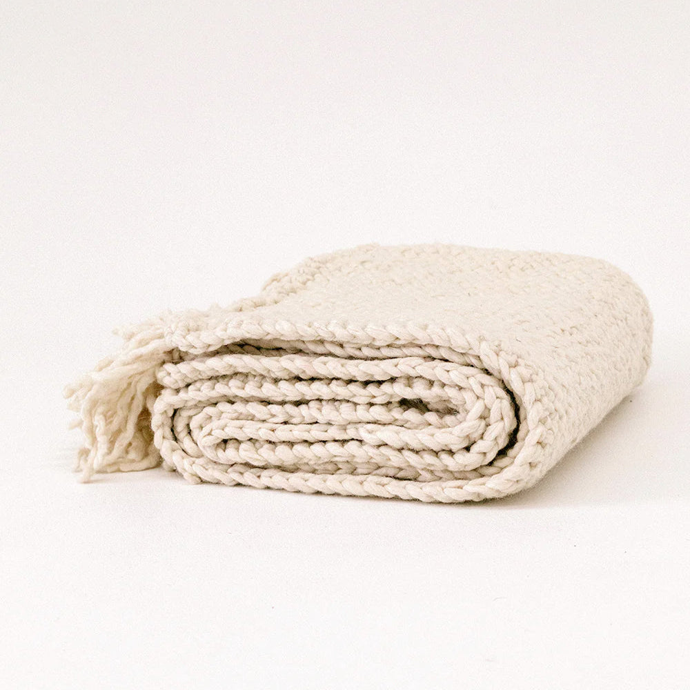 Folded beige blanket on a white background- Number 1