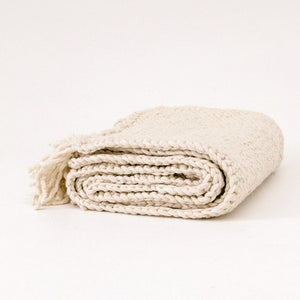 Folded beige blanket on a white background - Number 1