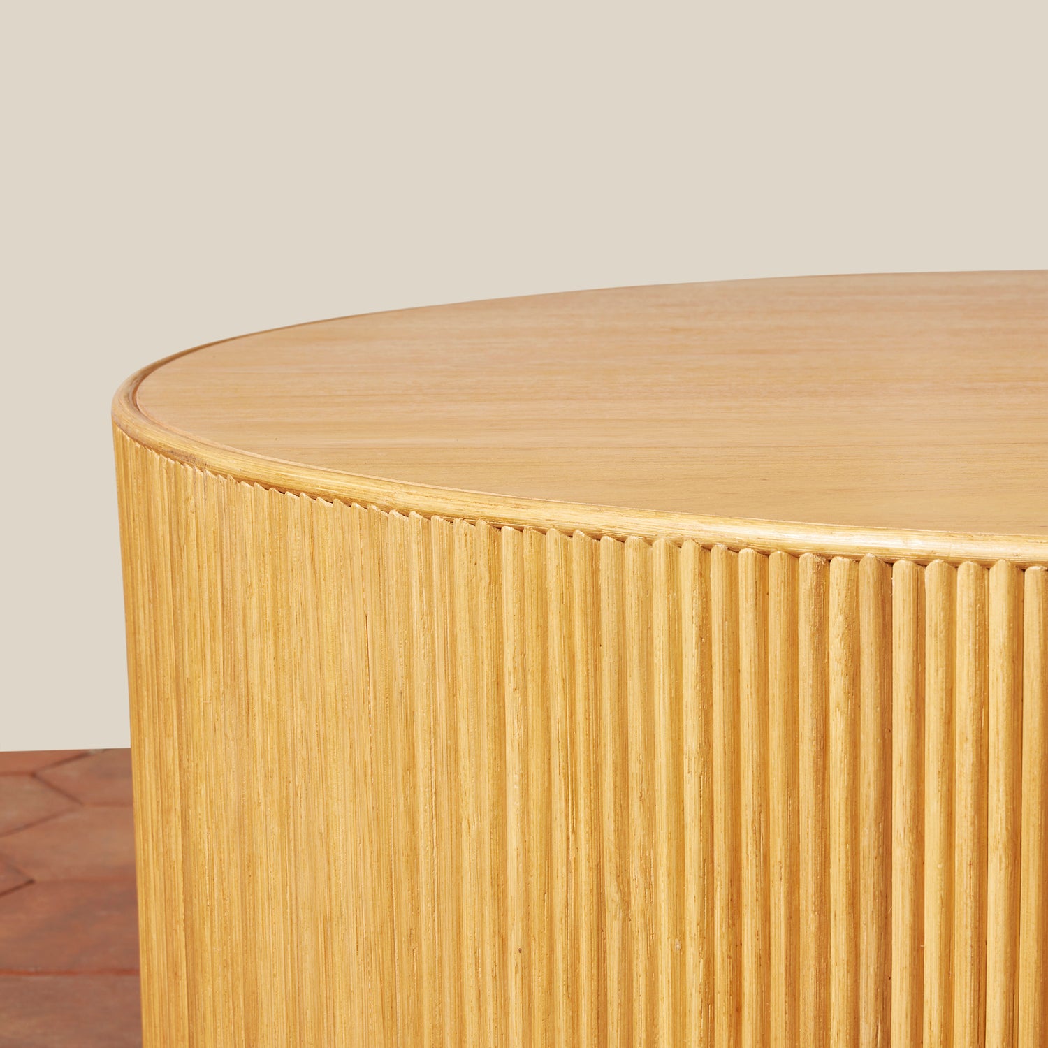 Round wooden side table with a ribbed texture on a neutral background- Number 11