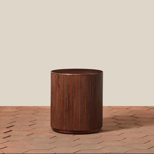 Wooden cylindrical side table on a wooden surface with a beige background - Number 1