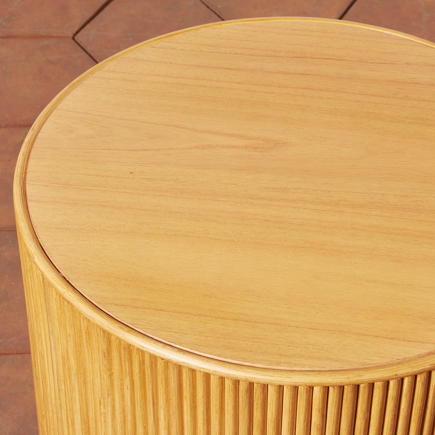 Wooden side table with a round top and cylindrical base on a wooden floor.- Number 9