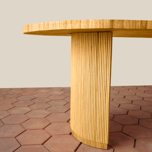 Wooden table with a textured cylindrical base on a hexagonal tile floor. - Number 5
