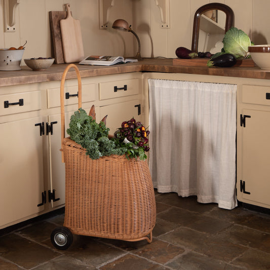 kitchen with beige cabinets and rolling market cart with fresh vegetables hanging out - Image 2