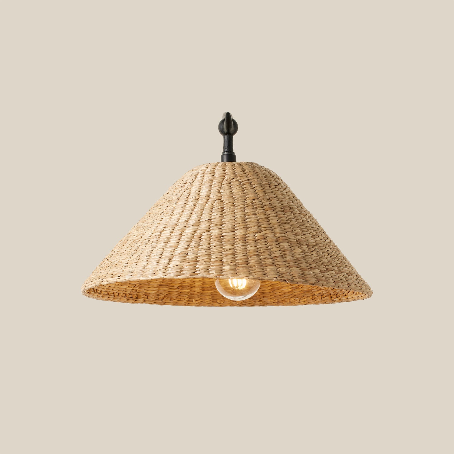 shade of rattan sconce with light turned on- Number 5
