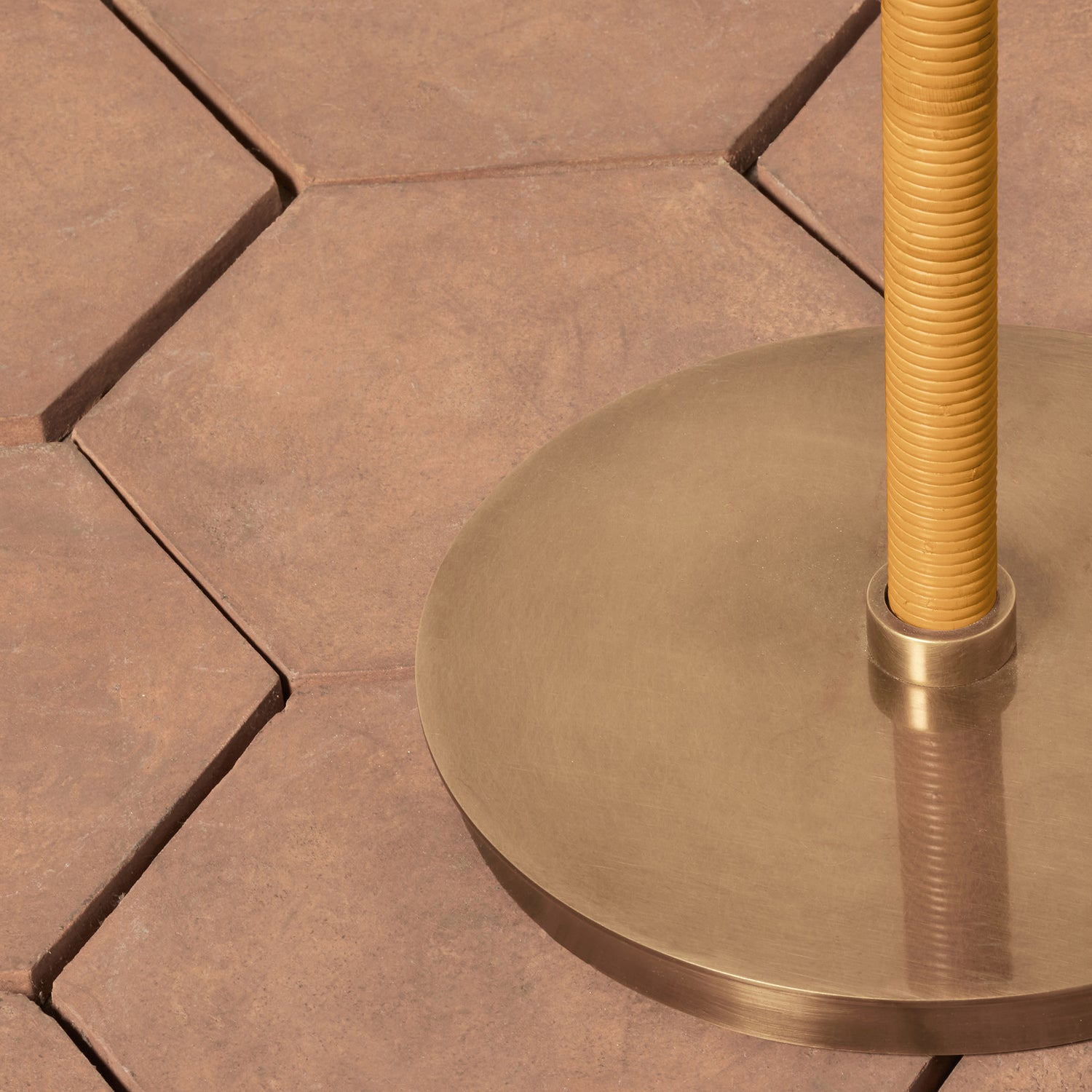 Close-up of a brown-colored lamp base on a stone floor - Number 5