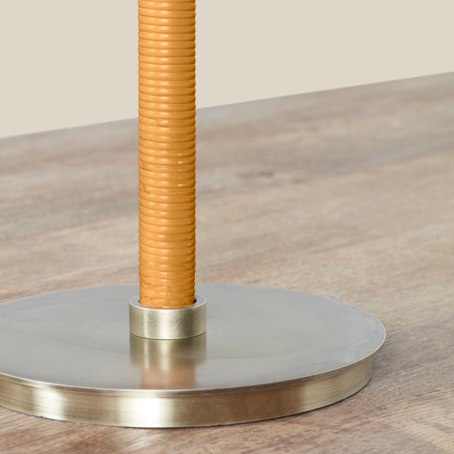 Close-up of a gold-colored lamp base on a wooden surface- Number 4