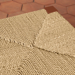 Close-up of a textured counter stool seat with a geometric pattern on a brown hexagonal tile floor. - Number 7