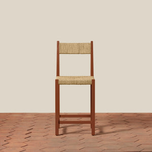 Wooden chair with woven seat and backrest on a beige wall and wooden floor. - Number 9