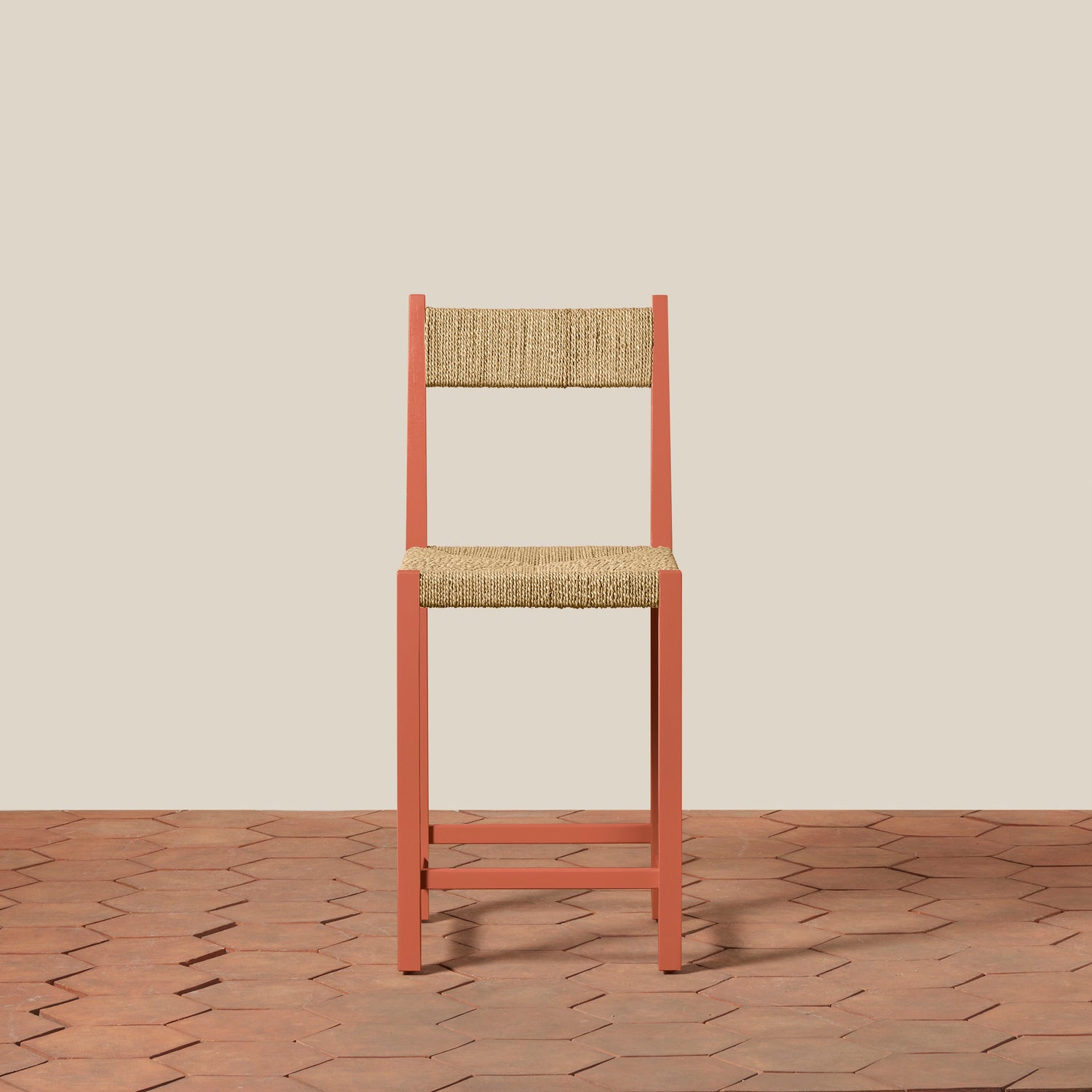 Wooden chair with woven seat and backrest on a beige wall and wooden floor.- Number 3