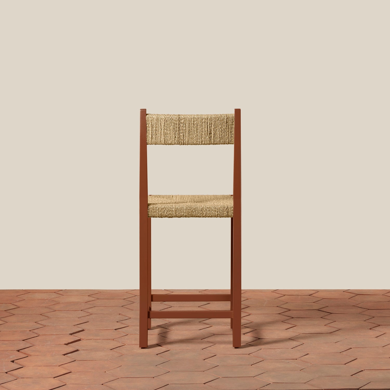 Wooden chair with woven seat and backrest on a beige wall and wooden floor.- Number 10