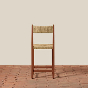 Wooden chair with woven seat and backrest on a beige wall and wooden floor. - Number 10