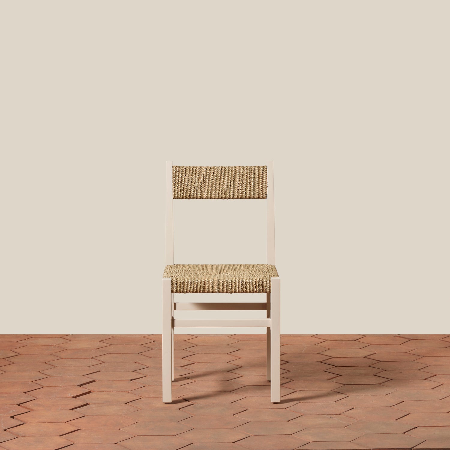 Chair with woven seat and backrest on a wooden floor and beige wall- Number 17