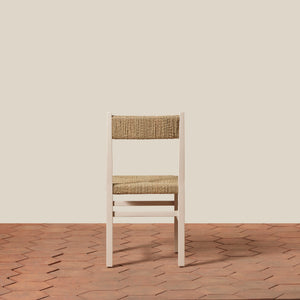 White chair with woven backrest on a wooden floor and beige wall - Number 18