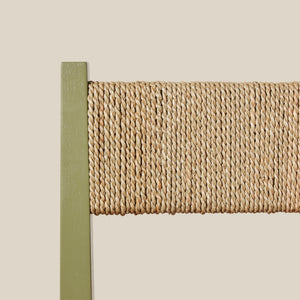 Close-up of a woven chair back with a green frame on a beige background - Number 25