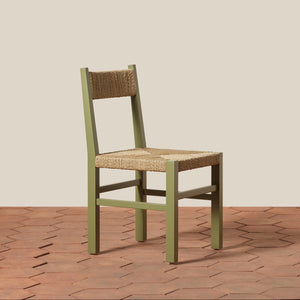 Green chair with woven seat on a wooden floor and beige wall background - Number 15