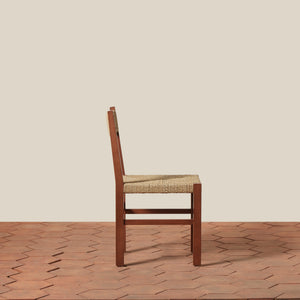 Wooden chair with woven seat on a wooden floor and beige wall background - Number 10