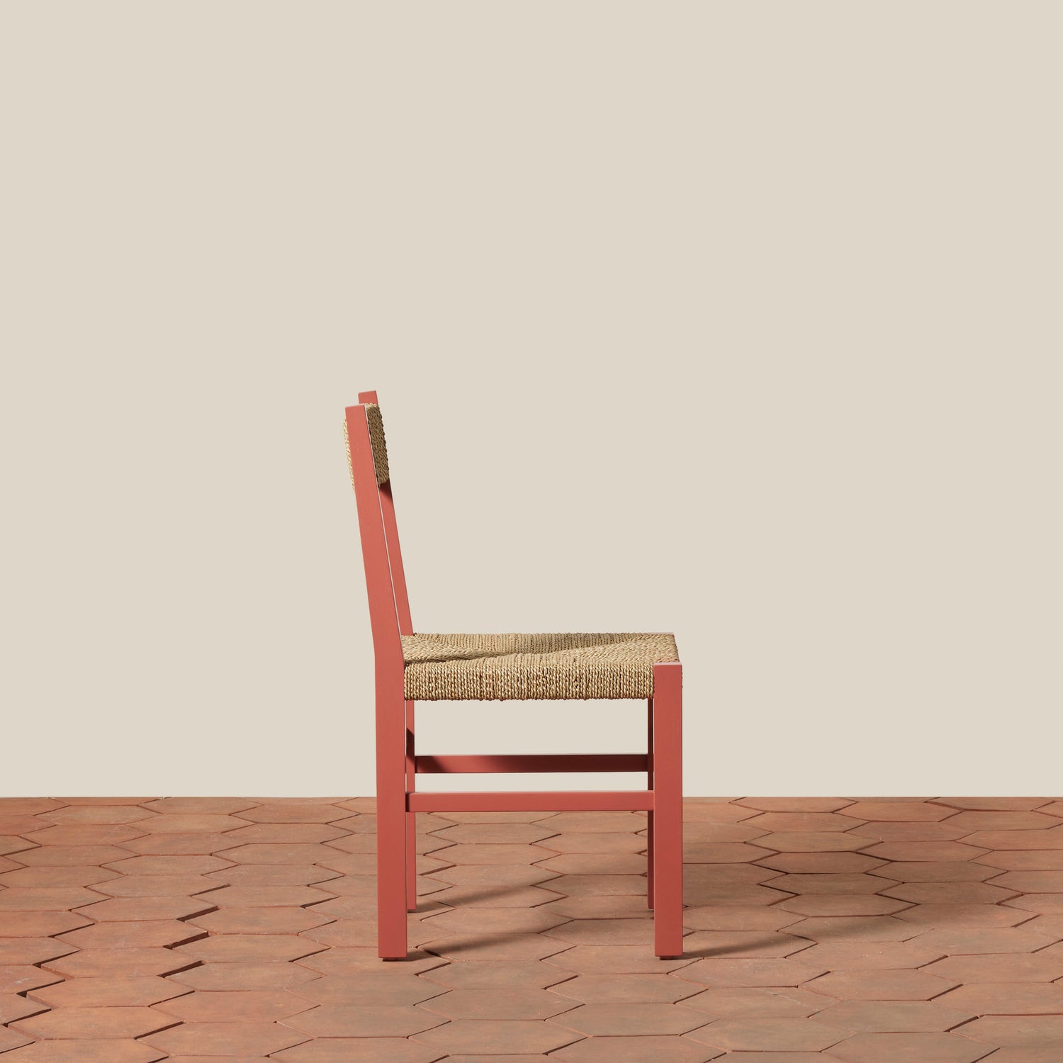 Chair with woven seat on a wooden floor and beige wall- Number 4