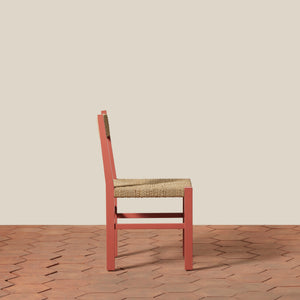 Chair with woven seat on a wooden floor and beige wall - Number 4