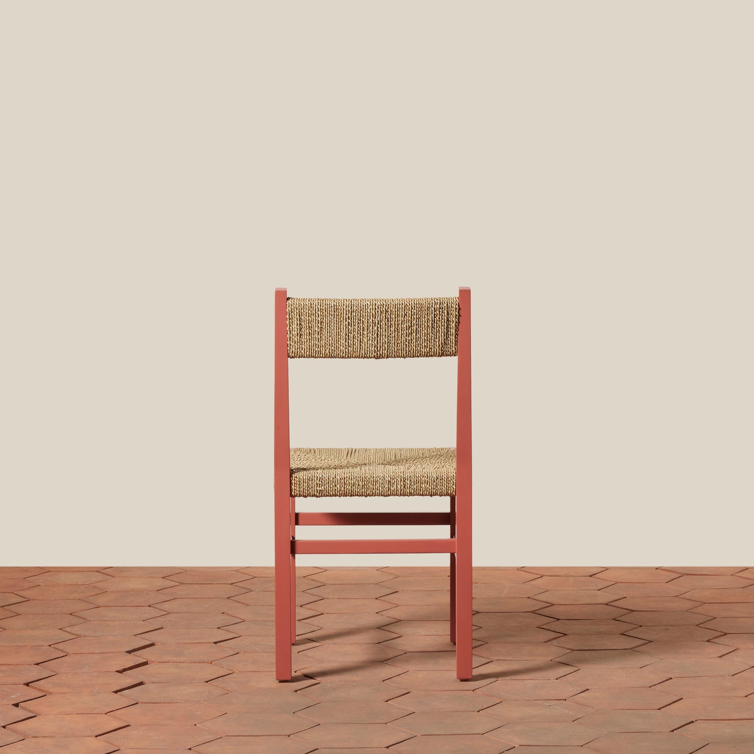 Chair with woven seat and backrest on a wooden floor and beige wall- Number 6