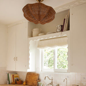 Kitchen with white cabinets, wooden countertops, and a window with lace curtains. - Number 2
