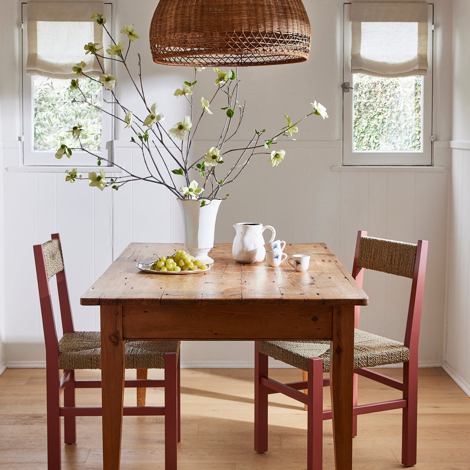 Dining room with wooden table, chairs, and decorative elements.- Number 2