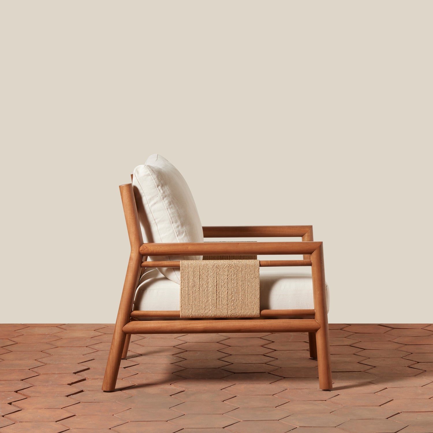 Wooden armchair with a woven side on a wooden floor and beige wall background- Number 8
