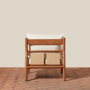 Wooden chair with white cushion and woven back on a wooden floor. - Number 4