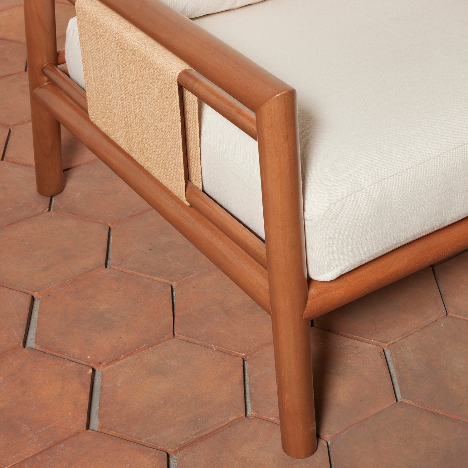 Wooden chair with beige cushion on a hexagonal tile floor- Number 6