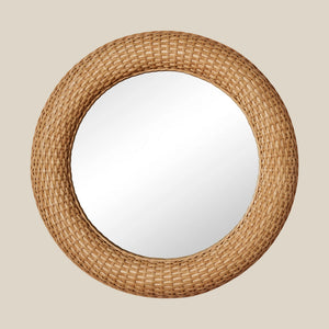 Round mirror with a woven rattan frame on a beige background - Number 1