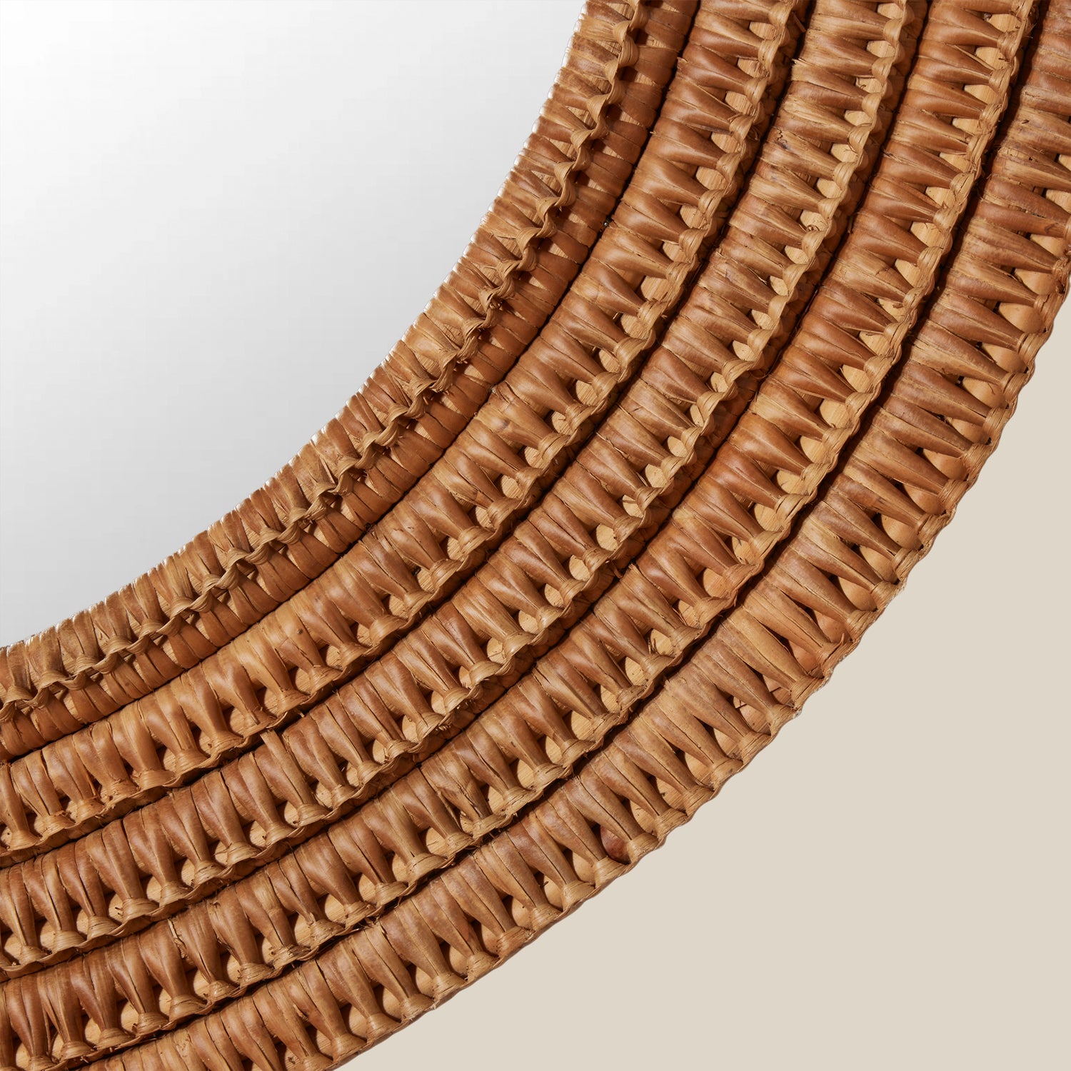 Close-up of a brown woven mirror on a light background- Number 2
