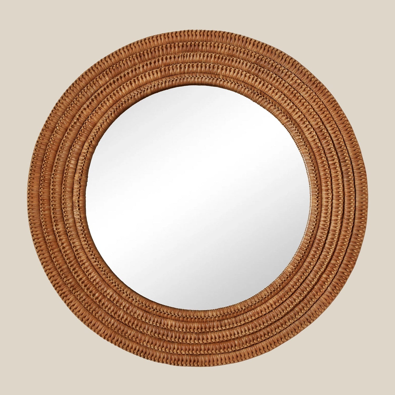 Round mirror with a woven brown frame on a beige wall- Number 1