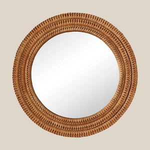 Round mirror with a woven brown frame on a beige background - Number 1